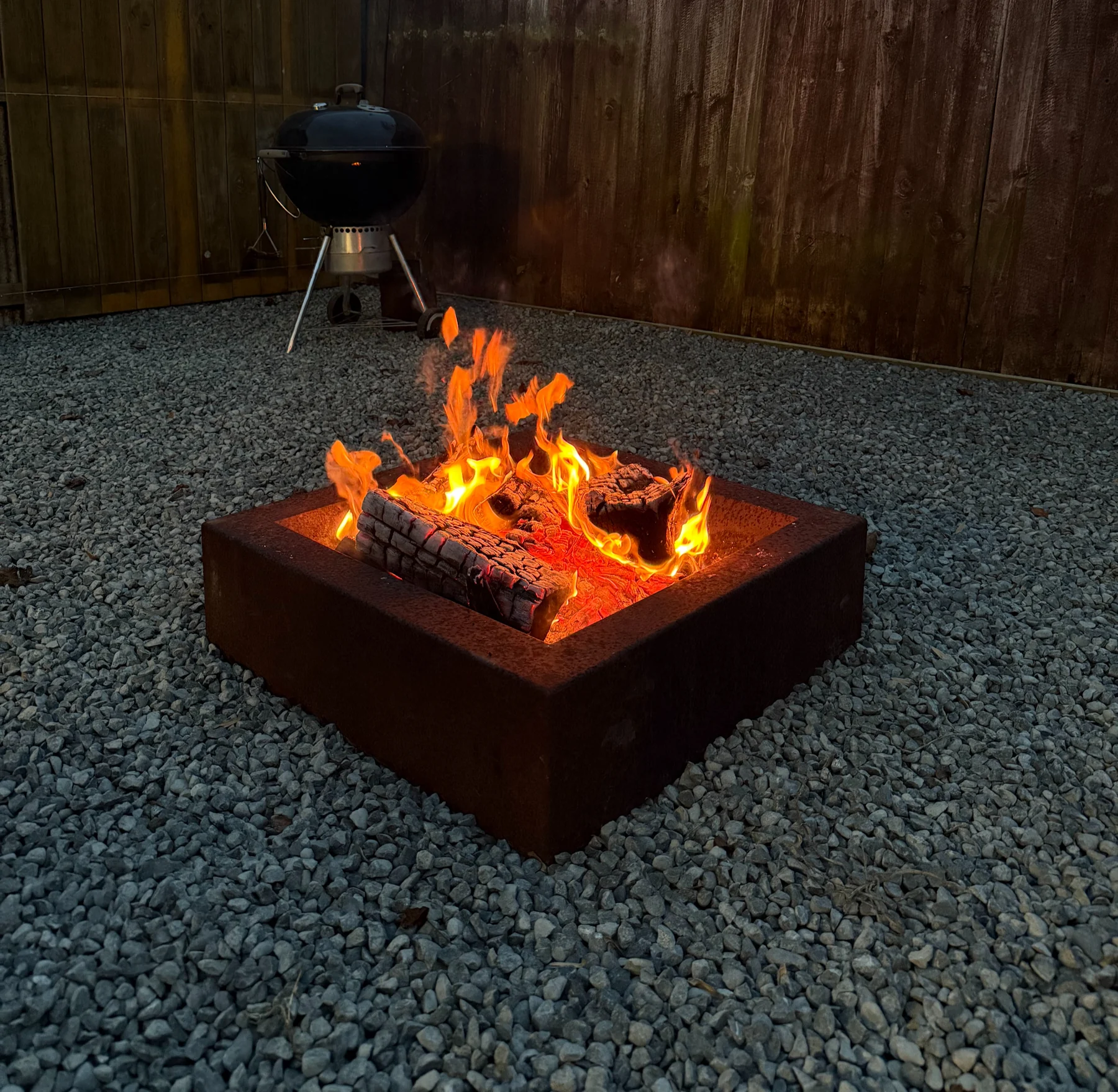 Corten steel firepit burning outdoors