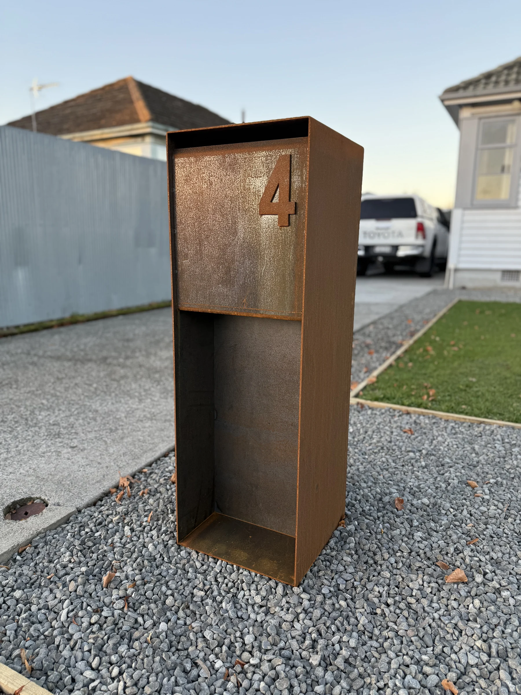 Installed Corten steel pillar letterbox